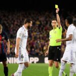 Who will referee the Clasico Copa del Rey final between Barcelona & Real Madrid and how many yellow & red cards has he dished out this season?
