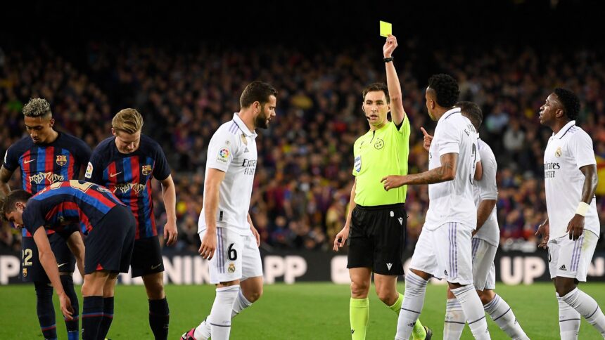 Who will referee the Clasico Copa del Rey final between Barcelona & Real Madrid and how many yellow & red cards has he dished out this season?